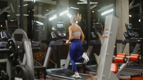 woman running on treadmill in gym