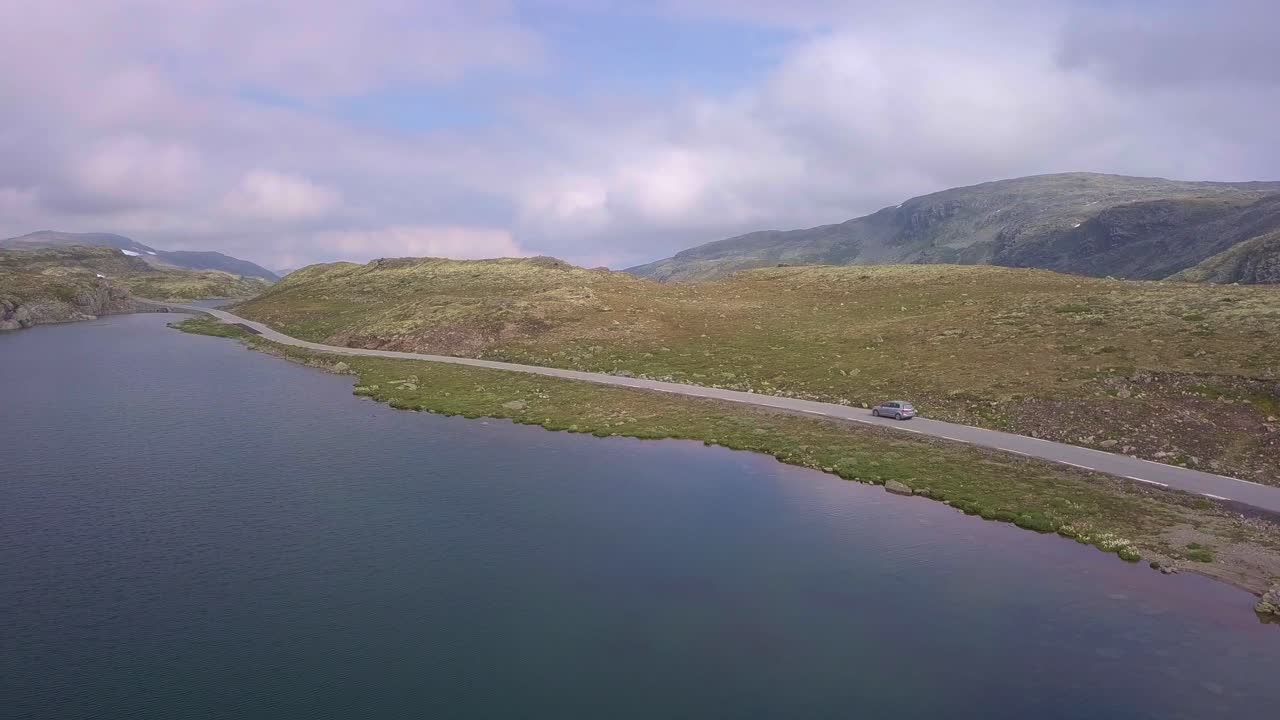 Drone following a grey car along the Aurlandsvangen road in Norway