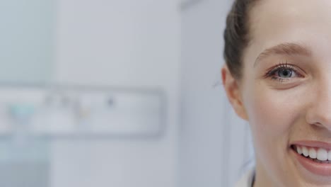 Half-portrait-of-happy-caucasian-female-doctor-laughing-in-hospital,-in-slow-motion-with-copy-space