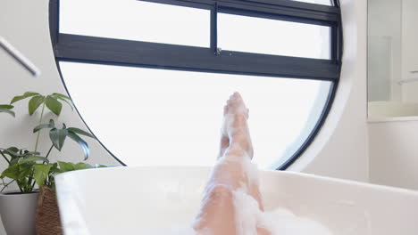 relaxing in bathtub, woman enjoying spa day with foam and bubbles