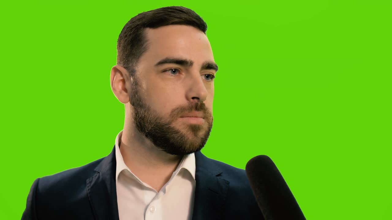 A stylish, positive young man gives an interview. Close-up. Chromakey.