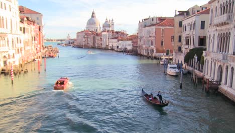 A-gondolier-rows-and-we-reveal-a-beautiful-canal-in-Venice-Italy