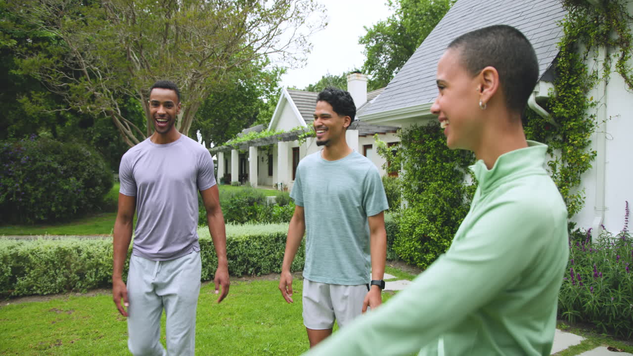 Young diverse friends laughing and enjoying time together outdoors in garden
