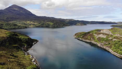 low drone aerial fast pan at kylesku. kylesku bridge, loch a' chairn bhain then followed by mountains of quinaig in background. (june 2019)