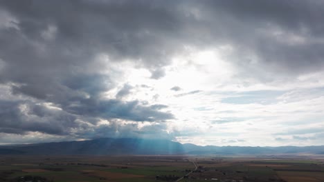 Dramatic-drone-shot-of-a-cloudy-sky-and-sunlight-rays-coming-through-the-clouds