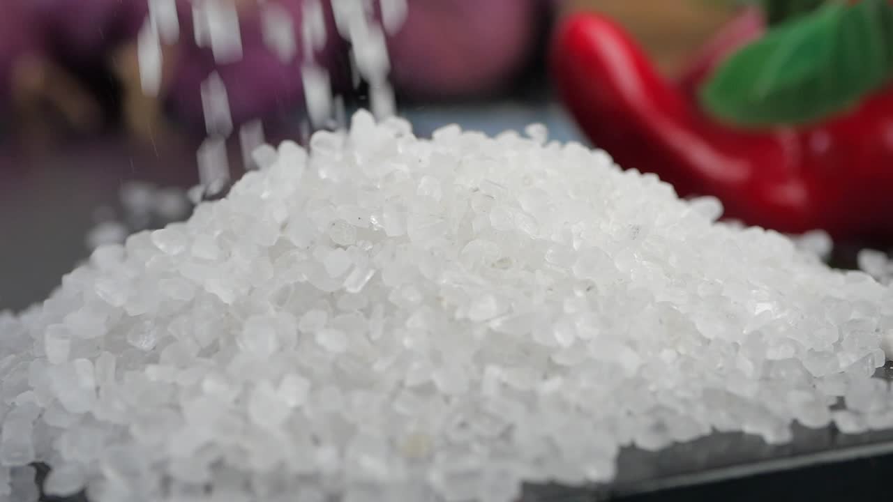 Sprinkling Coarse Sea Salt onto a Pile