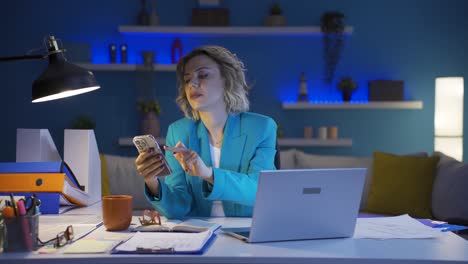 una donna che lavora in ufficio a casa che ha problemi e stress al telefono.