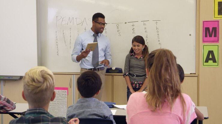 Schoolgirl and teacher at front of class, shot on R3D