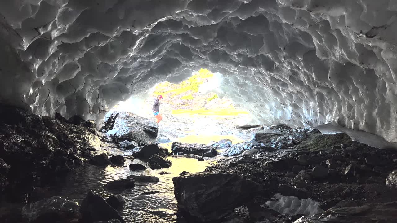 View from Ice Cave, Woman tourist exploring pristine nature, hiking New Zealand. Outdoors