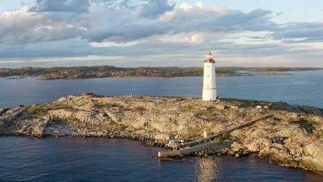 coastal lighthouse on the island of lille torungen in arendal, agder county, norway - aerial drone shot