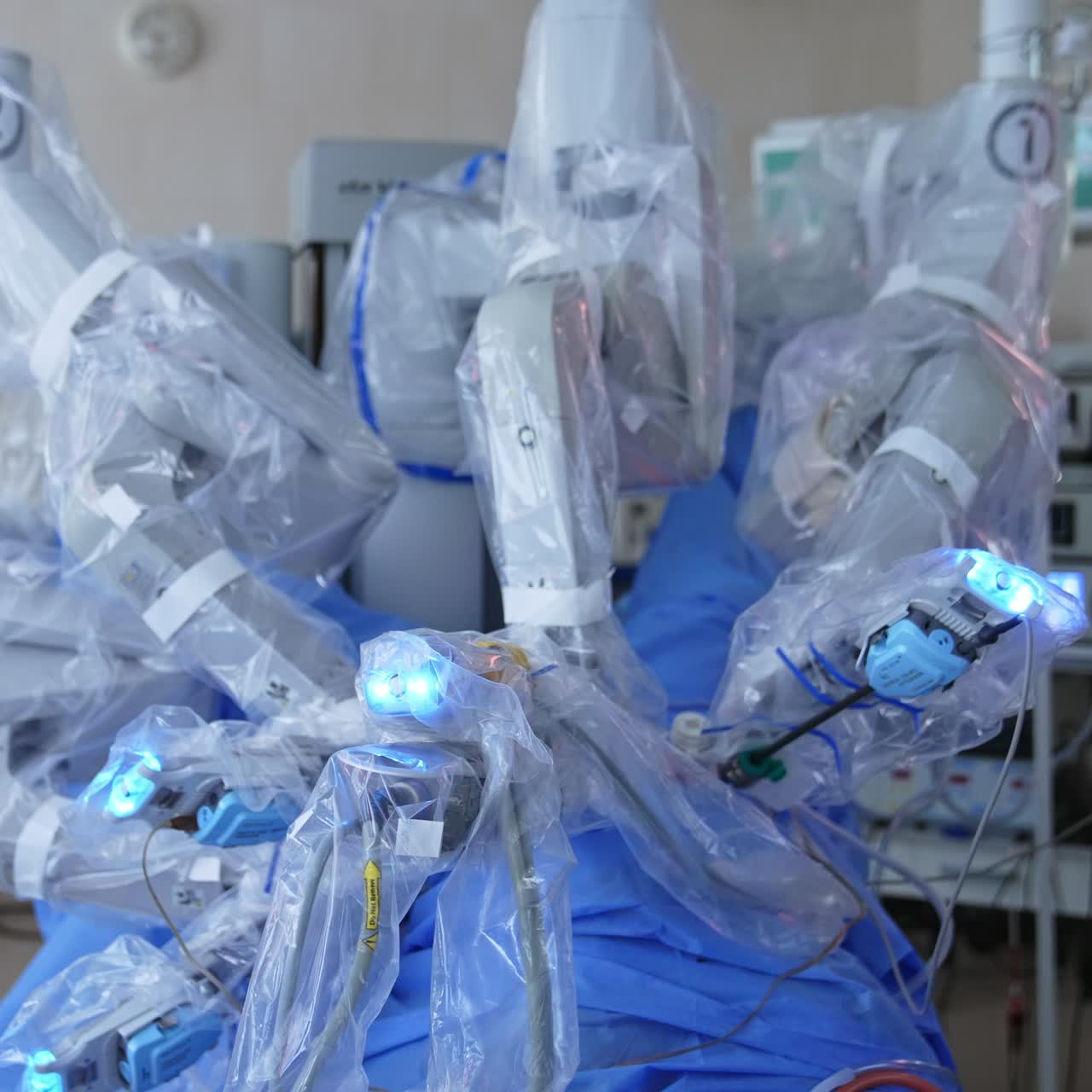 Carefully moving robotic arms during minimally invasive operation. Da Vinci equipment working in surgery room