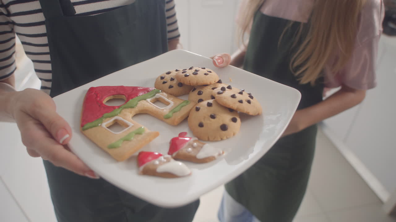 Unrecognizable Mother and Daughter Holding Plate with Baked Cookies