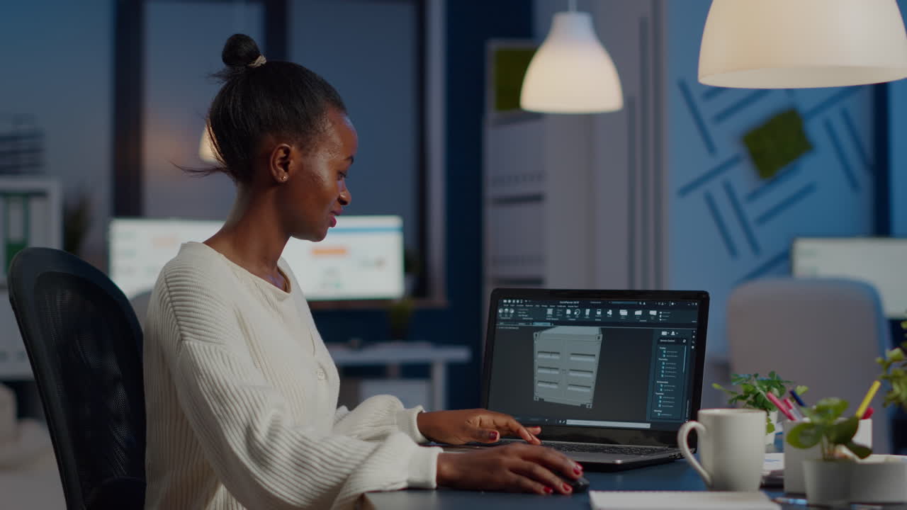 Enthusiastic african engineer analysing cad software to design a 3D container