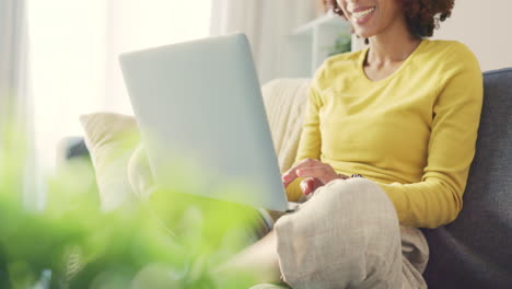 a black woman working remotely on a laptop