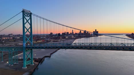 empty ambassador bridge with detroit skyline and river at dusk in a scenic aerial view