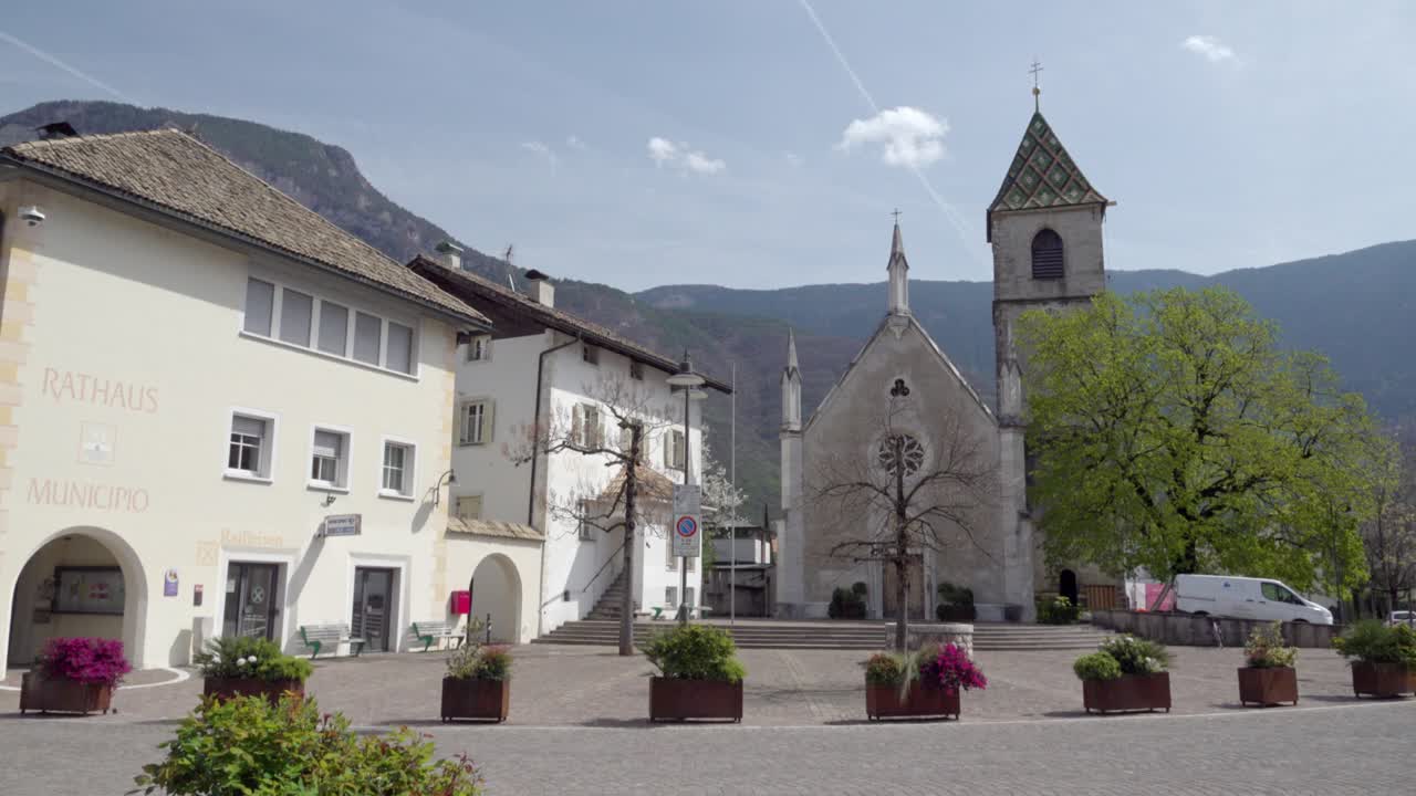 Picturesque Village Square with Church and Mountain View