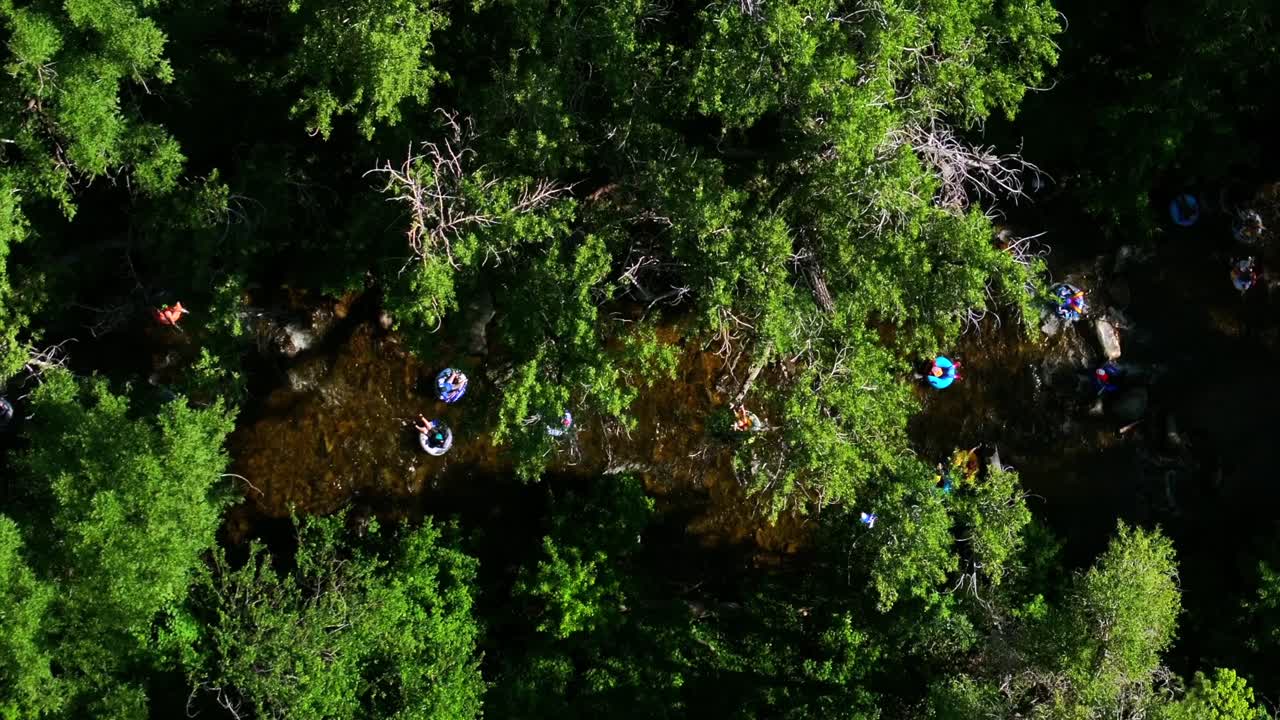 Boulder Creek early morning sunrise tube to work day Boulder Colorado aerial drone Birdseye view multiple tubing down the river Eldorado Canyon Golden South Platte Deckers sunny upwards motion
