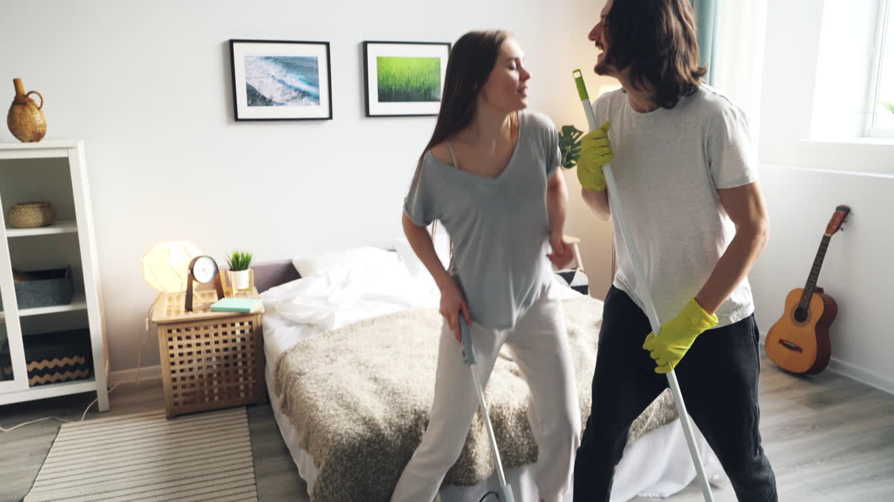 Couple Cleaning and Dancing