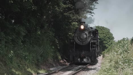 vintage steam engine approaching head on with a full head of steam