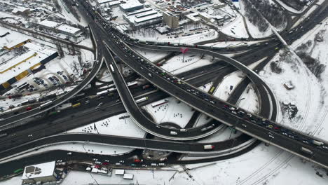 cars driving on highway interchange in city. aerial view winter car traffic