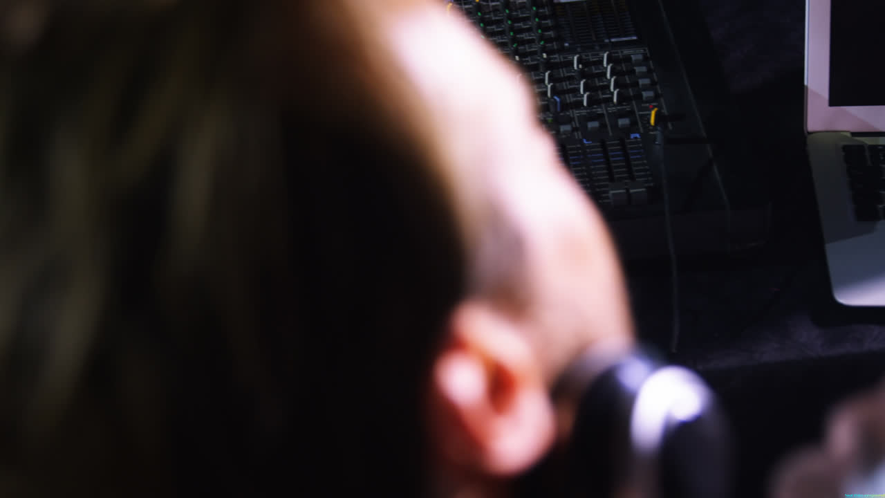 Dj man using sound mixer console at a concert in nightclub 4k