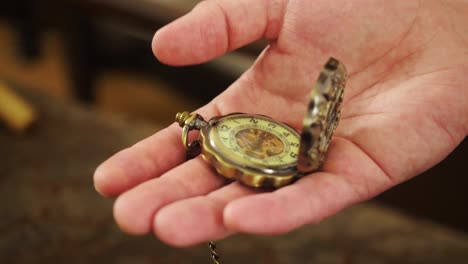 antique pocket watch in hand