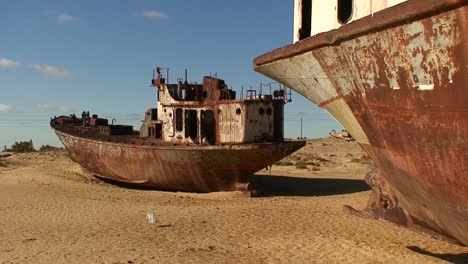 old abandoned ships signify the ecological disaster that is the aral sea in kazakhstan or uzbekistan