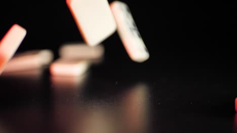 white domino dice fall on a black background