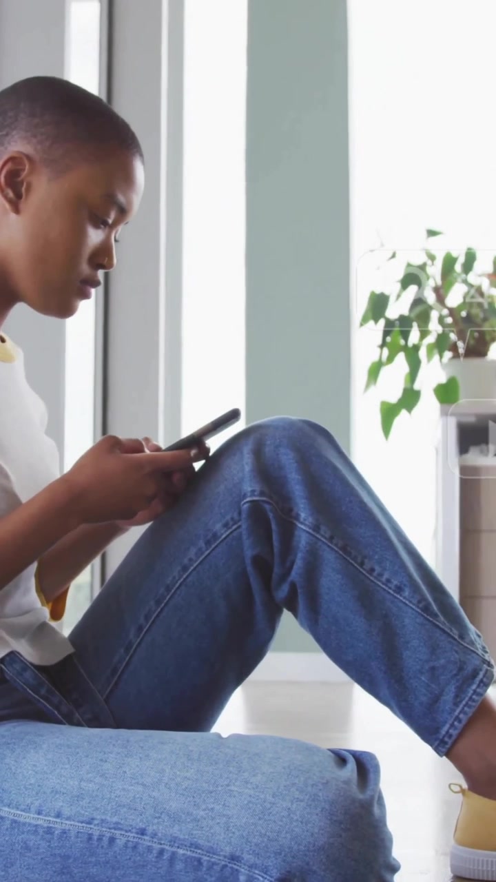 Animation of icons with numbers over african american businesswoman using smartphone in office