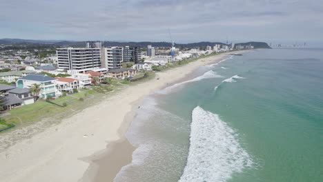 Shadow-Of-An-Airplane-Flying-Over-Coastal-Suburb-Of-Palm-Beach-In-Gold-Coast,-Queensland