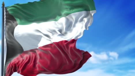kuwaiti flag is waving slowly against blue sky