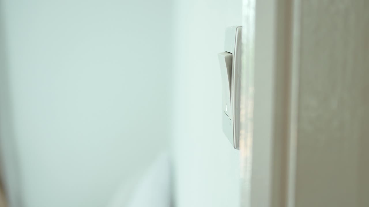 A finger turning on lighting switch