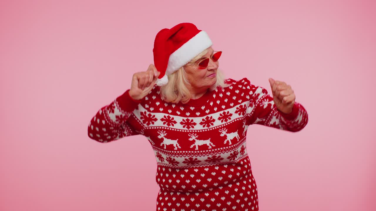 Senior christmas grandmother woman with deer antlers listening music dancing disco fooling around