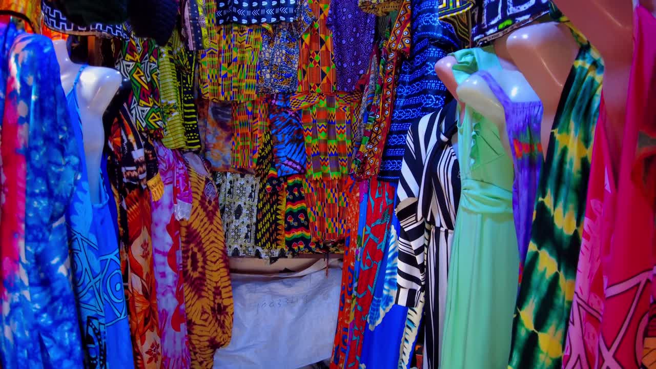 Traditional african clothing seller displays his wares at Serekunda market, Gambia