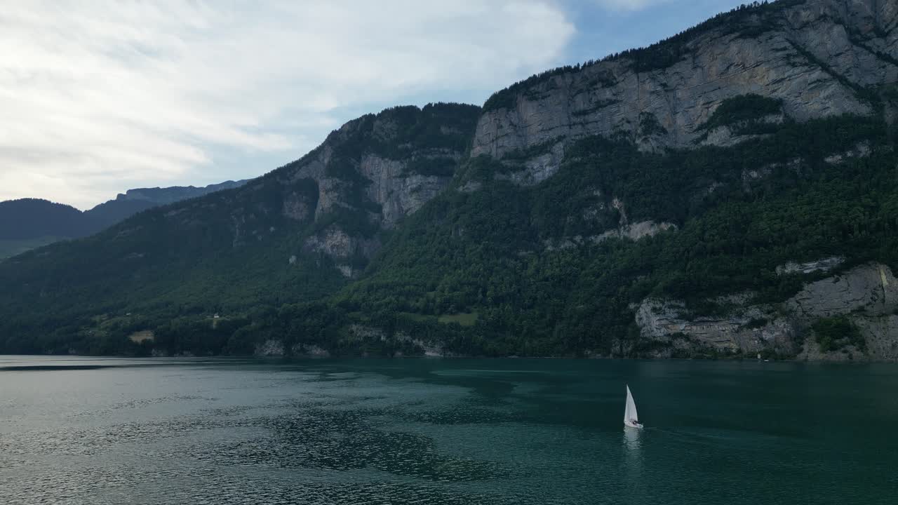escena tranquila de yate navegando en el lago walensee adornado con montañas