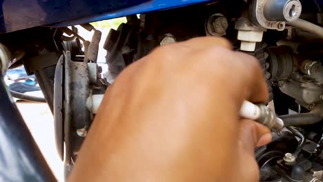 two-wheeler-motorbike-maintenance-at-day-from-flat-angle-in-details