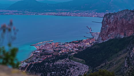 A-Time-Lapse-View-Of-A-Coastal-City-From-Daylight-To-Evening-With-Bright-City-Lights