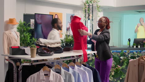 worker changing shop mannequin clothes