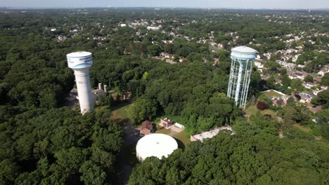 A-high-angle-view-over-water-towers-in-a-suburban-neighborhood-on-Long-Island,-NY-on-a-sunny-day