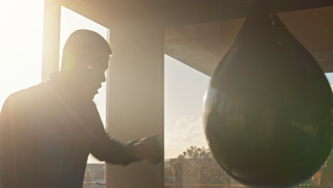 Man,-punching-bag-and-training-for-exercise