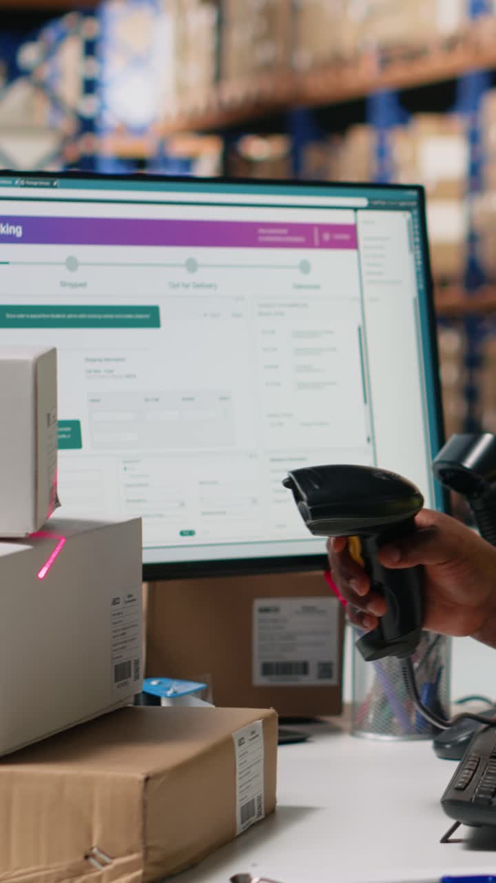 Vertical Video Employee scanning awb tags after packaging operations in a distribution center