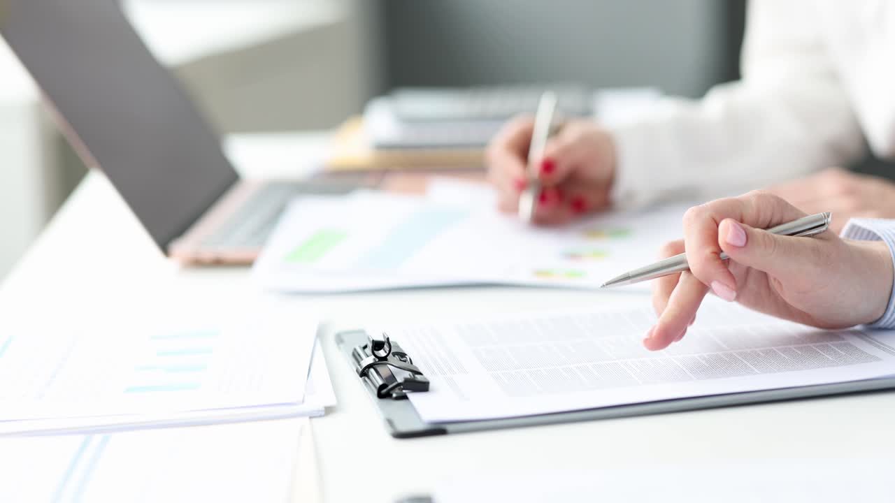 Business women studying data in documents 4k movie