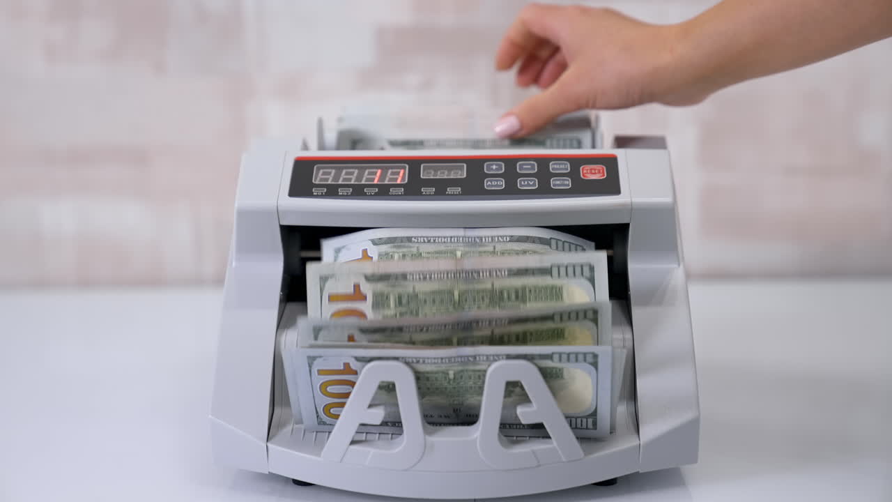 Money counting machine. Counting dollar banknotes.