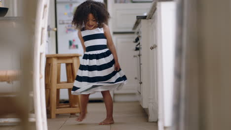 beautiful little girl dancing wearing pretty dress showing off cute dance having fun at home enjoying summer fashion