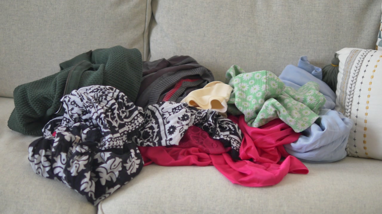 Colorful Pile of Laundry on a Comfortable Sofa