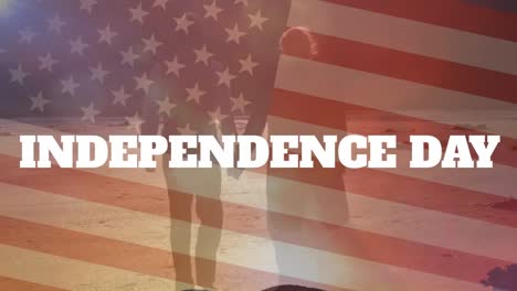 animation of independence day text, flag of america, rear view of caucasian couple walking on beach