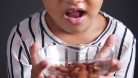 child eating almonds