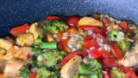 top view of cooking italian risotto with vegetables and chicken