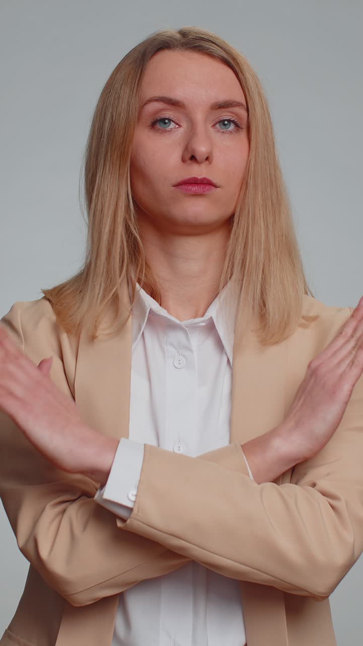 Woman say no hold palm folded crossed hands in stop gesture warning of finish prohibited access