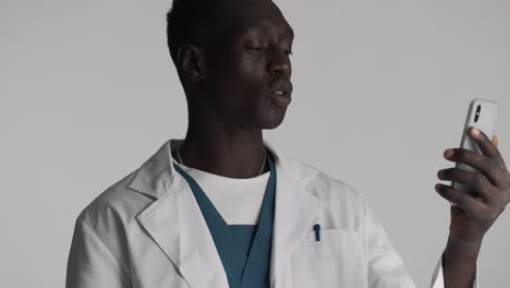 african american doctor on grey background.